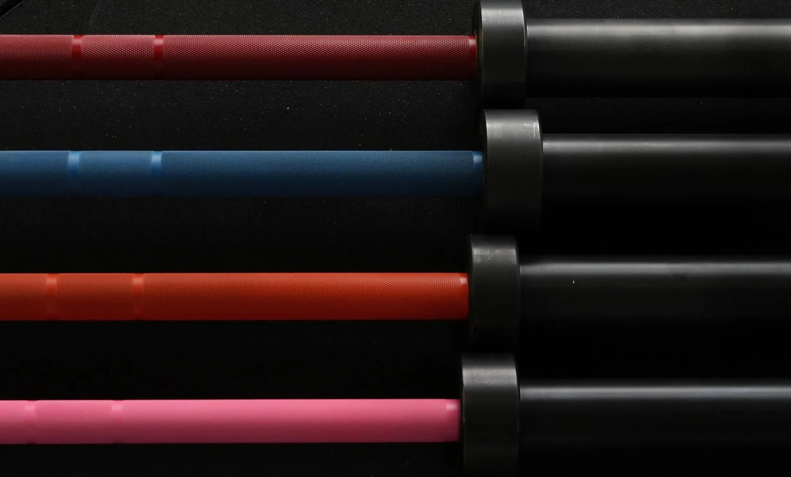 a row of barbells in a commercial gym