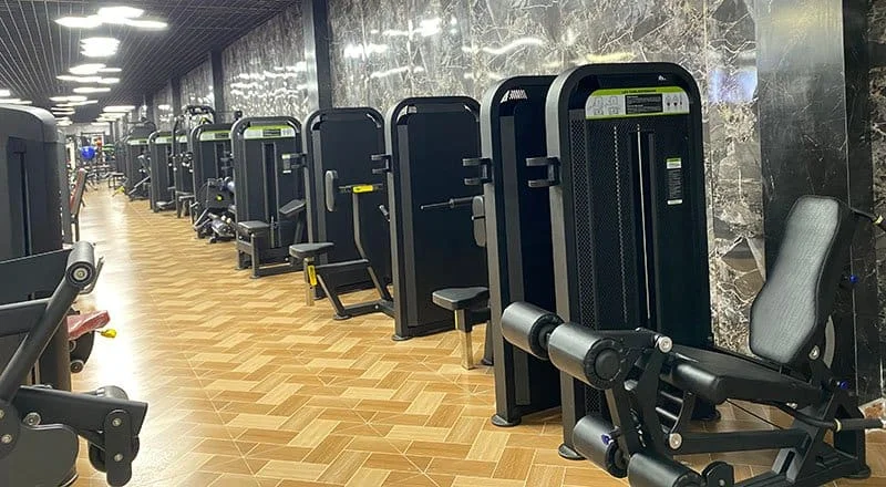 A fully equipped commercial gym with various stations